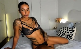 tattooed-seductress-posing-in-sexy-black-lingerie-on-the-bed